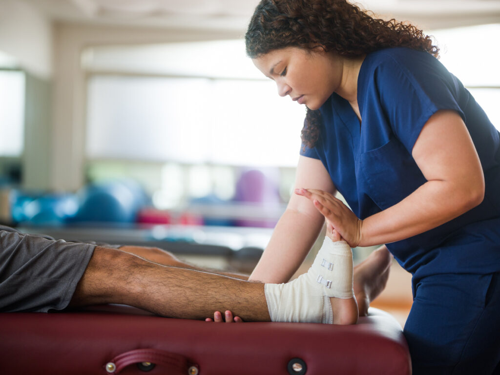 doctor helping patient with work injury