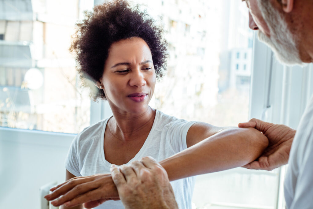 woman-seeing-physician-about-repetitve-task-injury