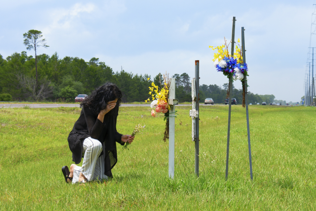 woman grieving at site of auto collision