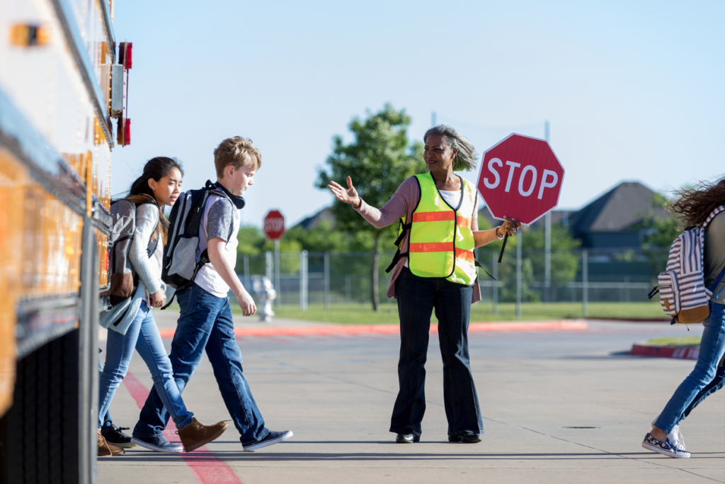 crossing-guard-helping-kids-cross-road