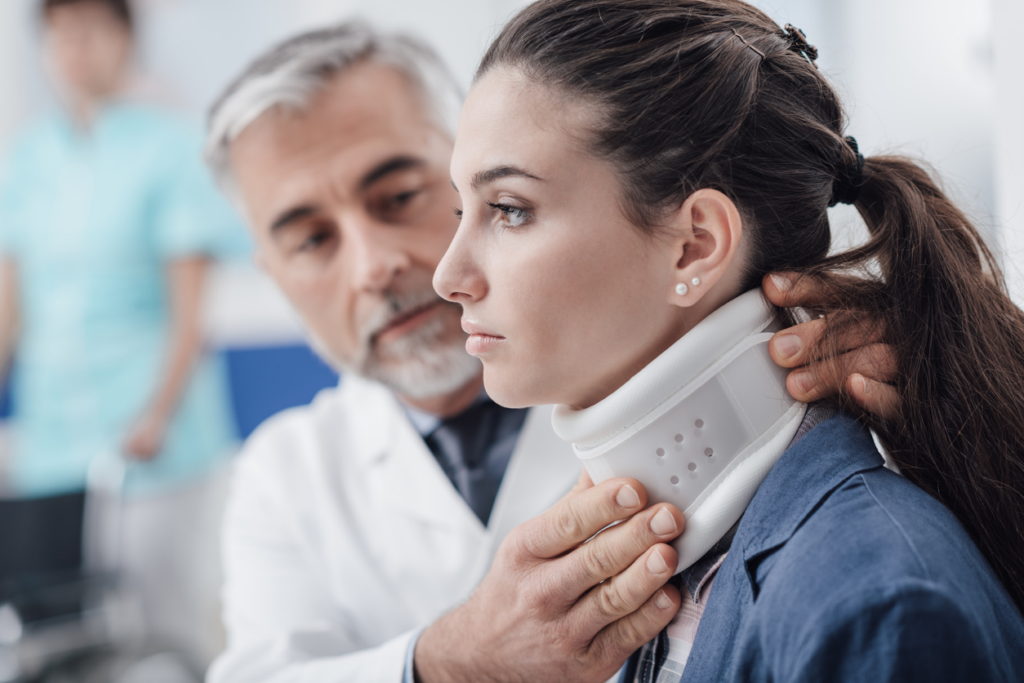 woman with spinal injury being examined by doctor