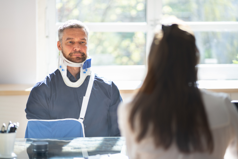 injured man meeting with lawyer regarding workers compensation claim