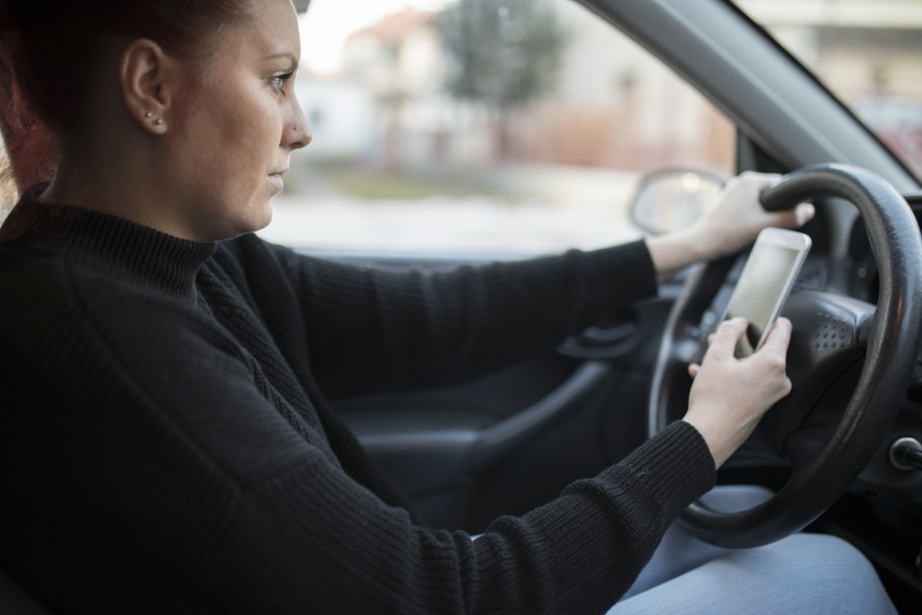 woman-texting-while-driving-and-at-fault-for-personal-injury