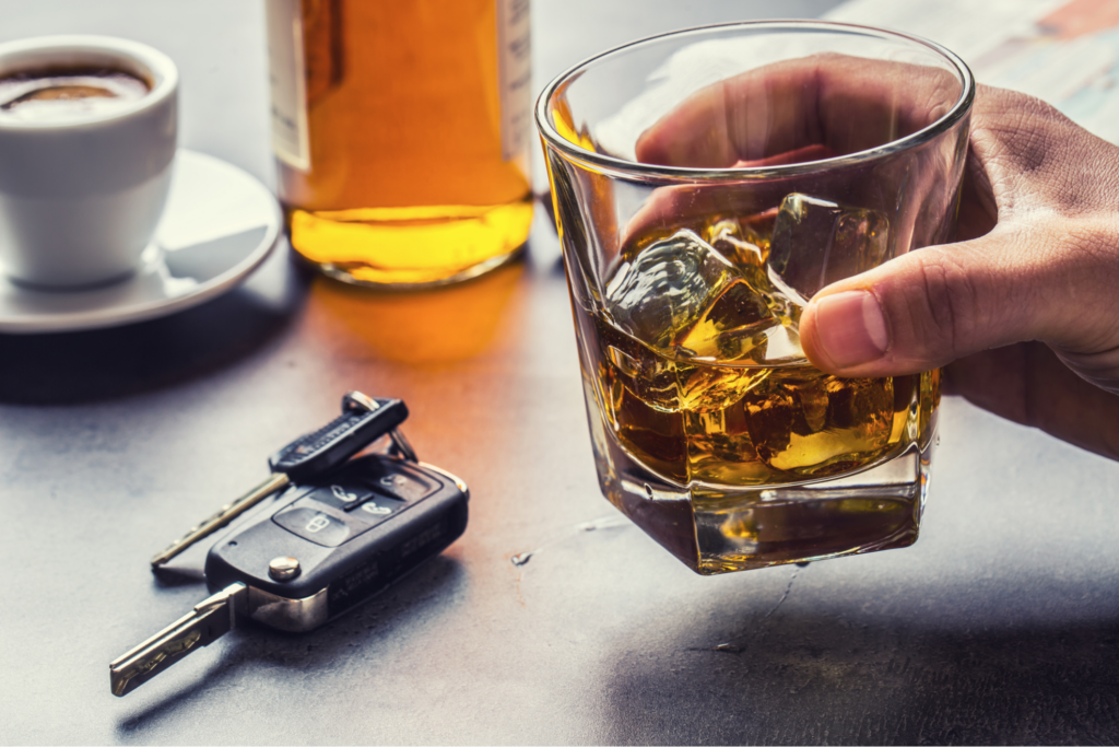 person at bar drinking with car keys on table