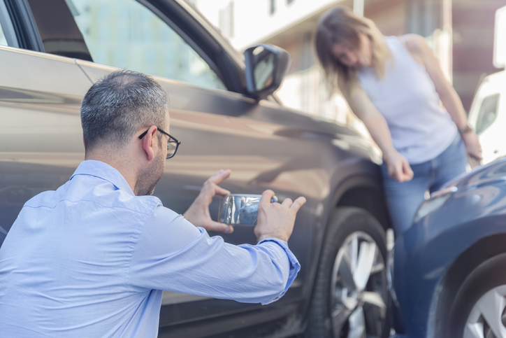 man taking photos of parking-lot-accident-sc