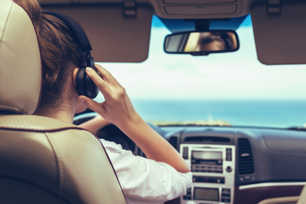 woman-wearing-wireless-headphones-while-driving
