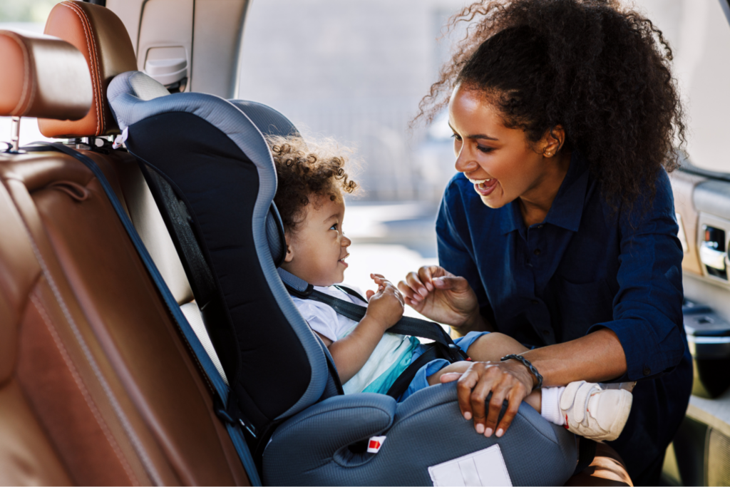 mom-placing-baby-in-safety-car-seat