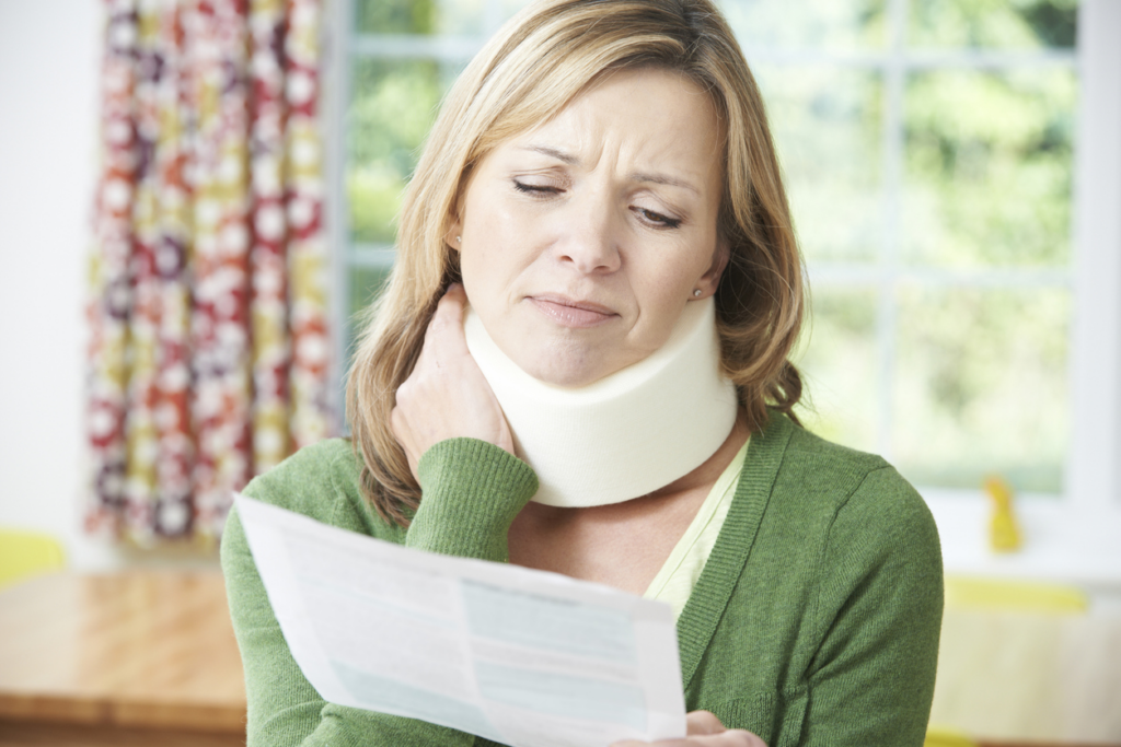 woman-in-neck-brace-reviewing-SC-whiplash-lawsuit