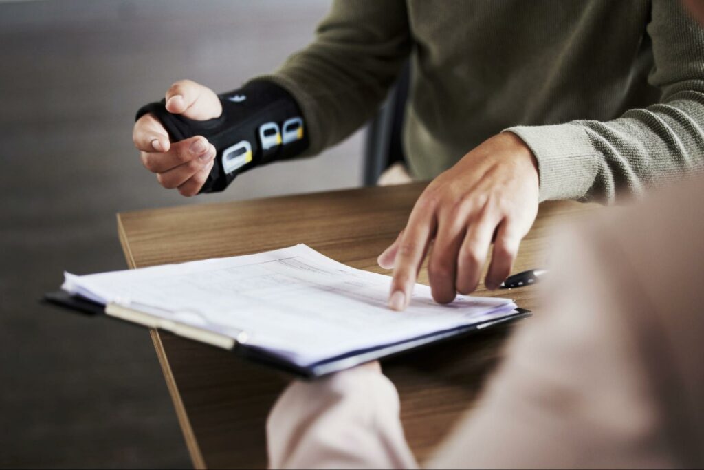 person-with-broken-wrist-filling-out-paperwork