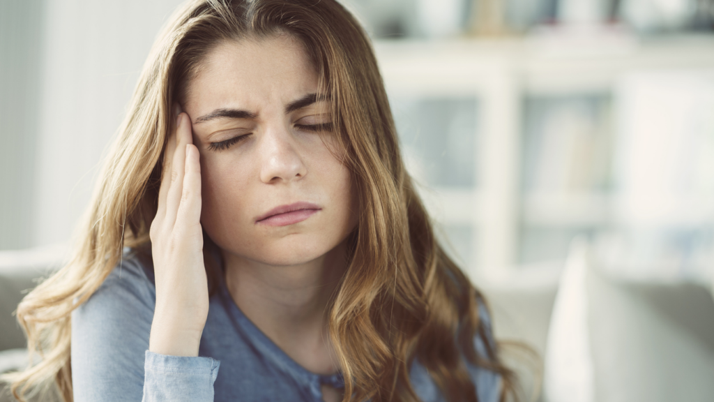 woman-rubbing-head-from-concussion