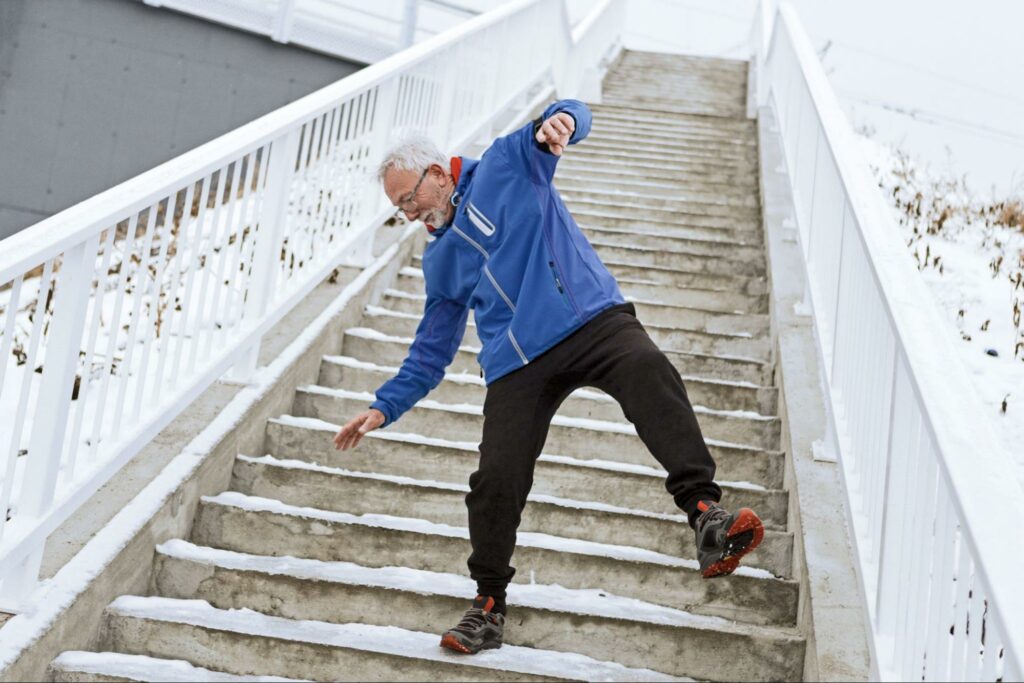 man-slipping-on-icy-stairs